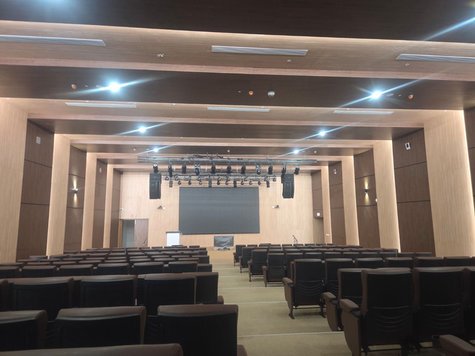 Government auditorium in Chennai rear hall view showing stage, ceiling treatment, wall treatment, and seating.