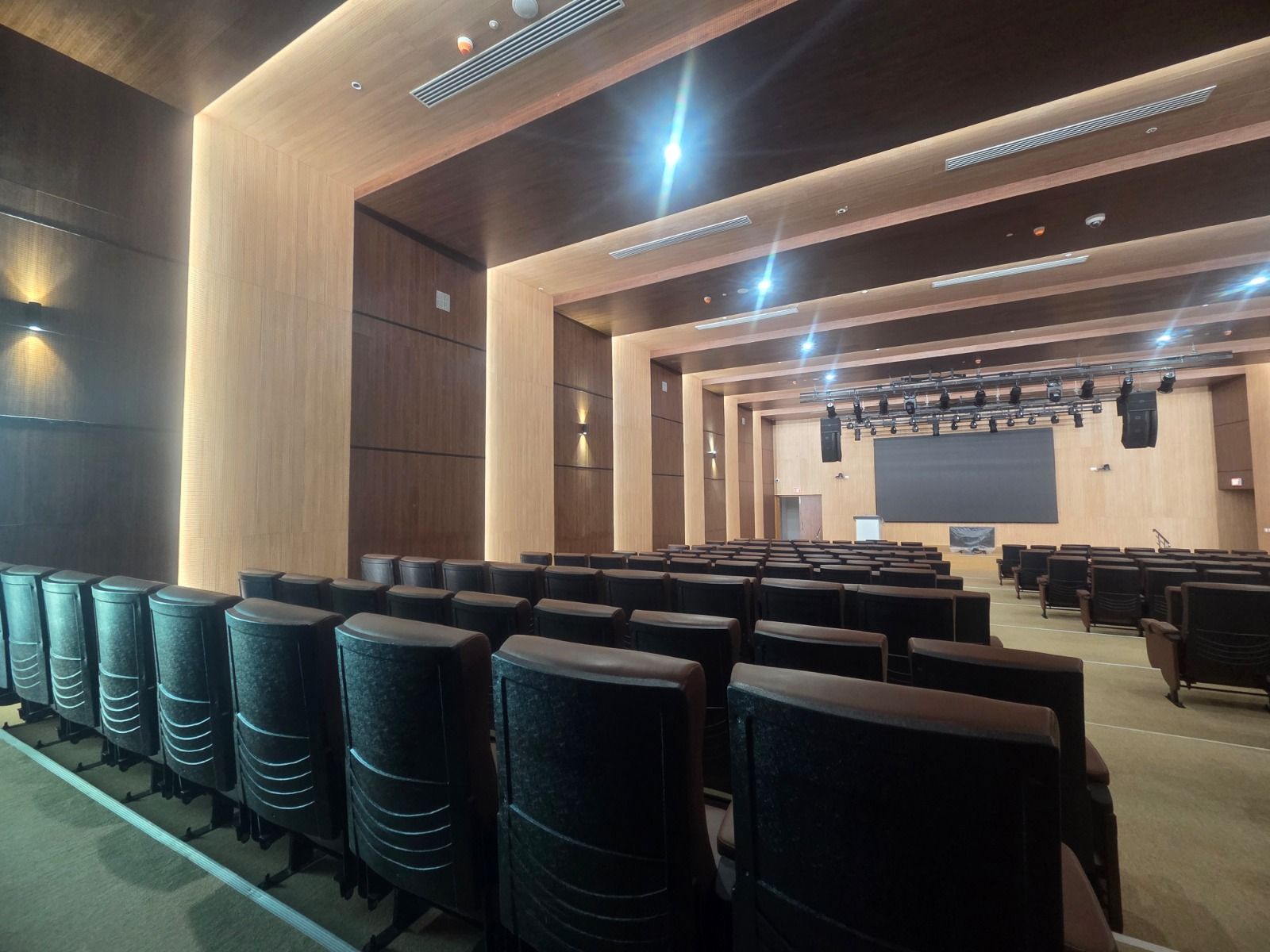 Government auditorium in Chennai wide angle showing seating rows and rear wall treatment.