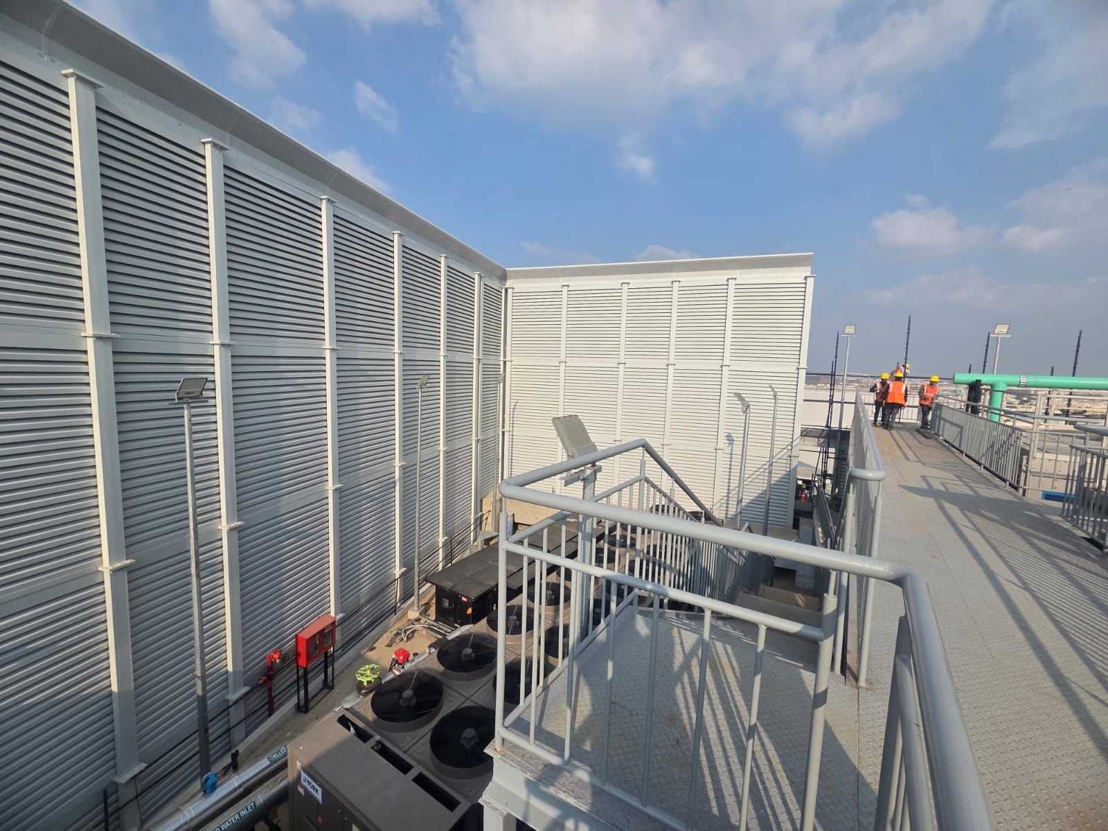 Corner view of the Bangalore acoustic louver enclosure showing two faces meeting and installation context.