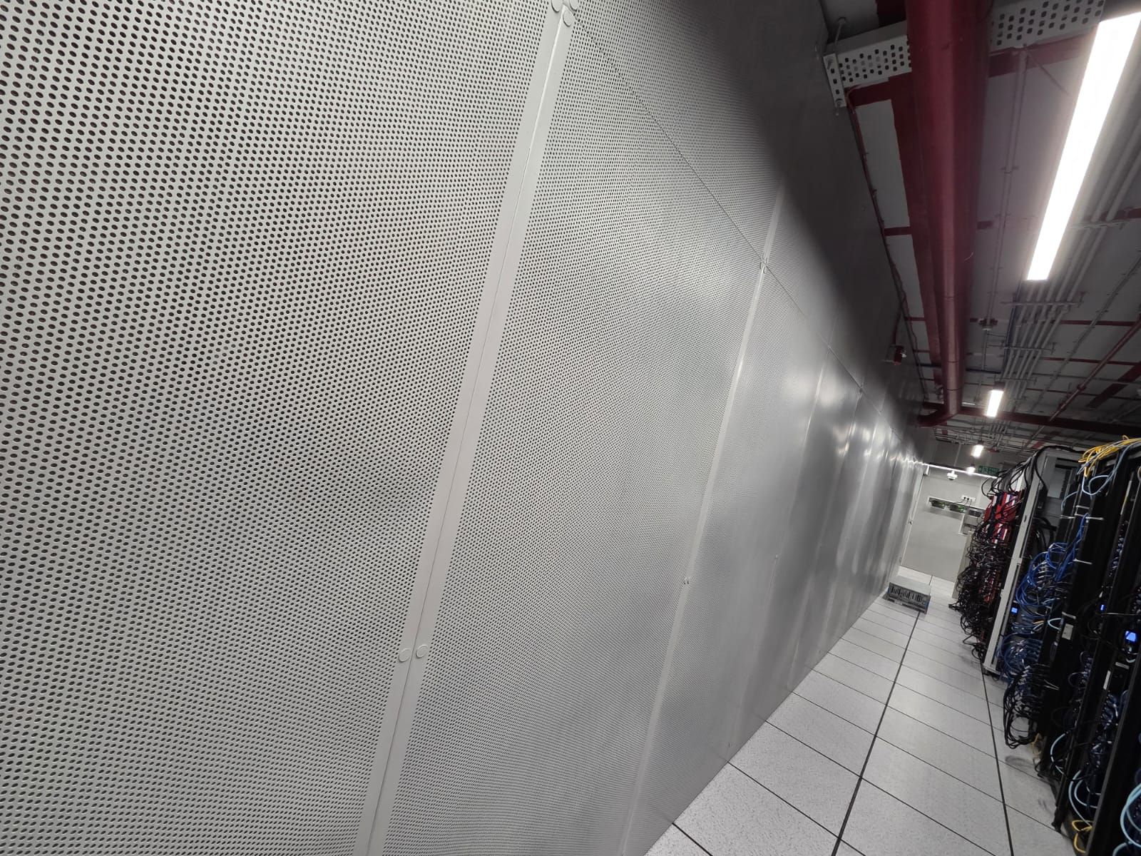 Close-up detail of the MetPan perforation pattern used in the Hyderabad server room treatment.